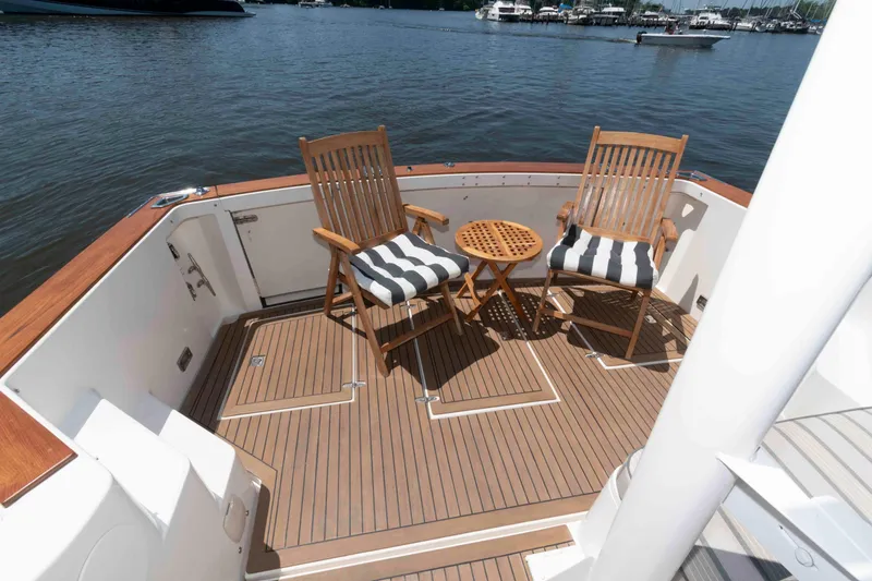 Slide: The Image of Deck of 1998 Sabre 36 Hardtop Express with chairs and table, overlooking marina. - 7