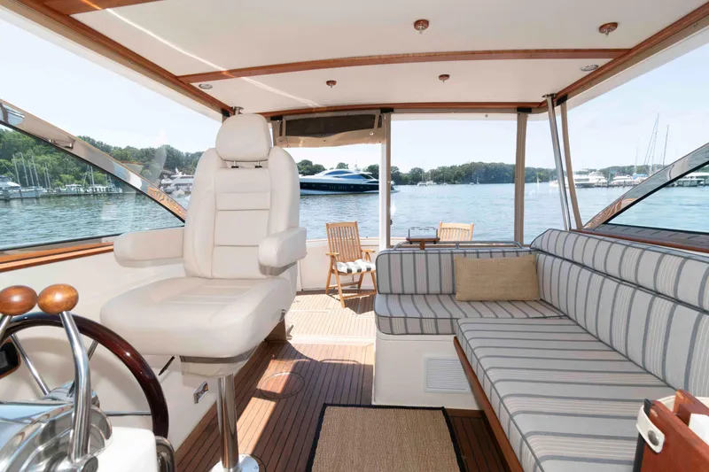 Slide: The Image of Interior of 1998 Sabre 36 Hardtop Express yacht with striped seating and water view. - 9