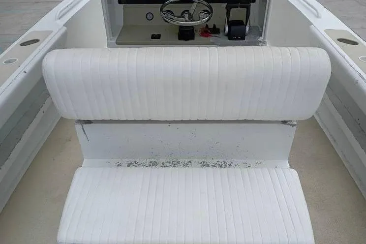 Slide: The Image of 2005 INTIMIDATOR 32 CC boat interior with white seating and steering console. - 11