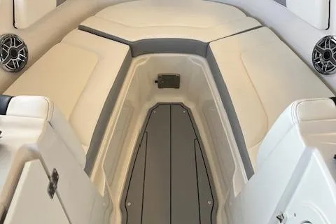 Slide: The Image of 2025 Chaparral 23 Surf boat interior with cushioned seating and speakers. - 10
