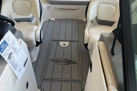 Slide: The Image of 2025 Chaparral 23 Surf boat interior with seating and sleek flooring design. - 11