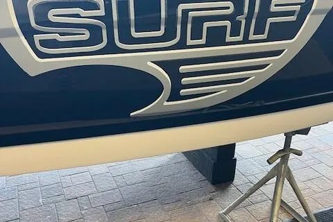 Slide: The Image of 2025 Chaparral 23 Surf boat logo on display stand. - 2