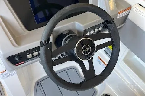 Slide: The Image of Steering wheel of 2025 Chaparral 23 Surf boat with control panel. - 9