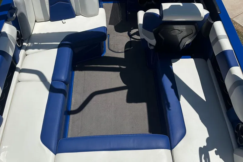Slide: The Image of 2021 Malibu Wakesetter 21 MLX interior with blue and white seating. - 12