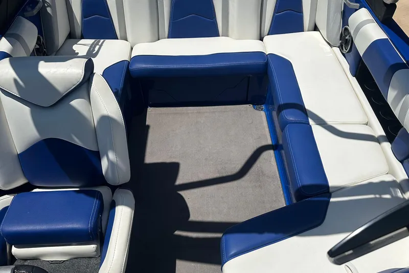 Slide: The Image of 2021 Malibu Wakesetter 21 MLX interior with blue and white seating. - 14