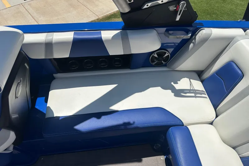 Slide: The Image of 2021 Malibu Wakesetter 21 MLX interior with blue and white seating. - 16