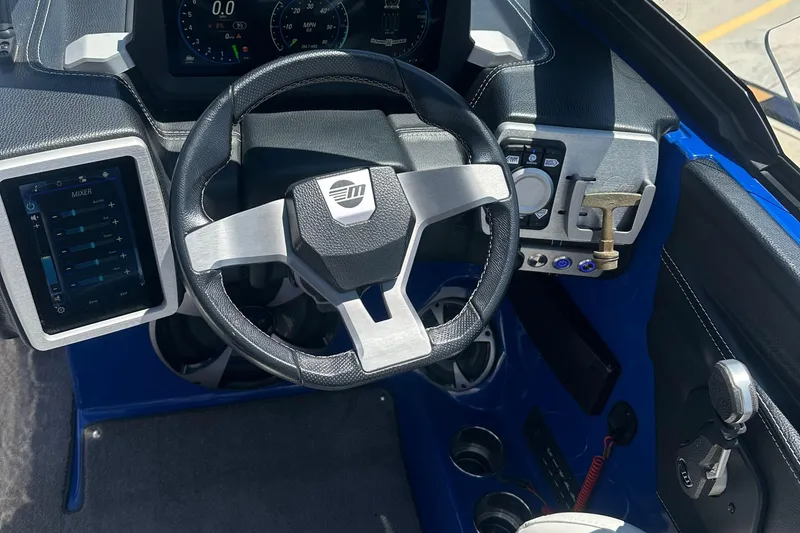 Slide: The Image of 2021 Malibu Wakesetter 21 MLX dashboard with steering wheel and control panel. - 17