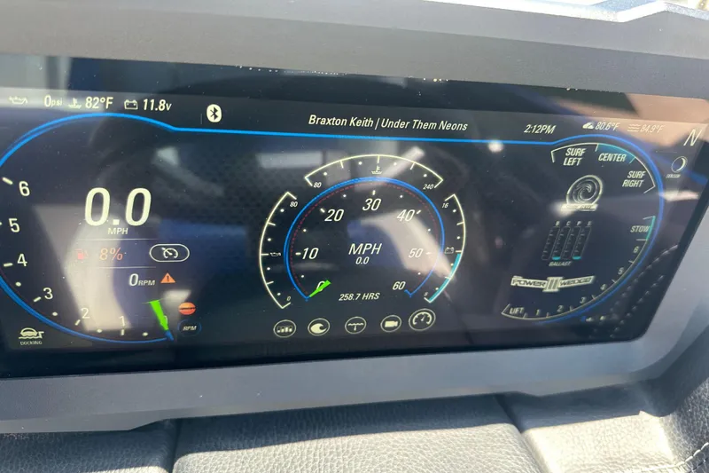 Slide: The Image of 2021 Malibu Wakesetter 21 MLX dashboard displaying speedometer and control settings. - 18