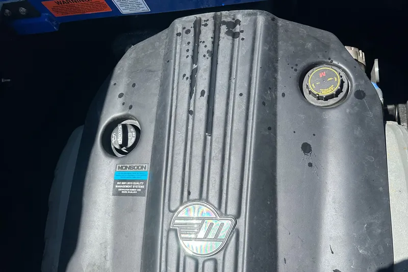 Slide: The Image of Engine cover of 2021 Malibu Wakesetter 21 MLX with Monsoon branding. - 19