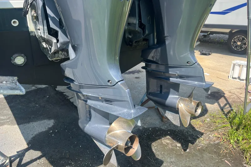 Slide: The Image of Twin outboard motors on a 2020 Jeanneau NC 895 boat, parked on a sunny day. - 10