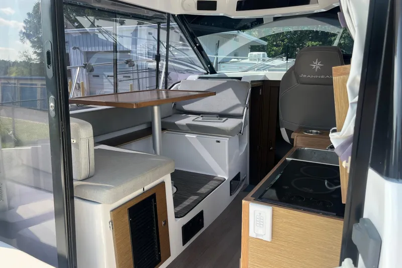 Slide: The Image of 2020 Jeanneau NC 895 interior with seating, table, and helm station. - 14