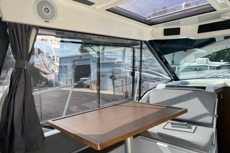 Slide: The Image of Interior of 2020 Jeanneau NC 895 boat with table and seating area. - 16