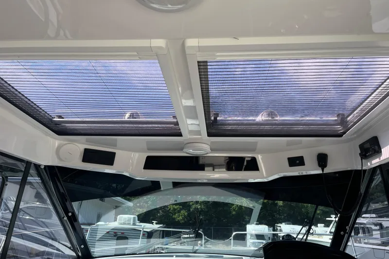 Slide: The Image of Interior view of 2020 Jeanneau NC 895 boat with sunroof and modern controls. - 17