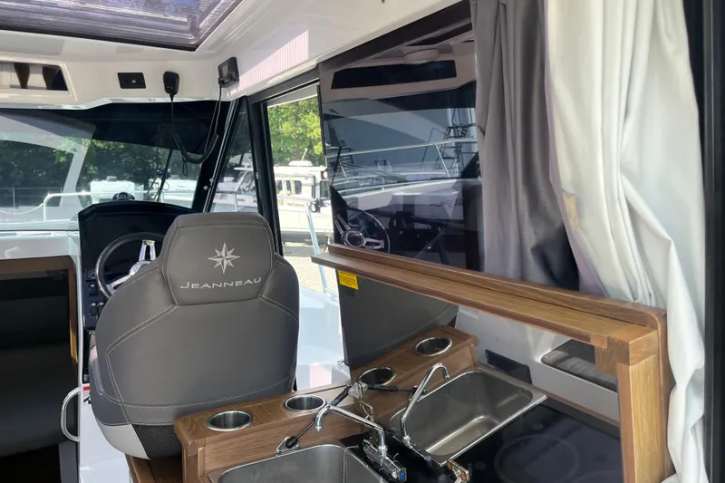 Slide: The Image of Interior of 2020 Jeanneau NC 895 boat with steering wheel and kitchenette. - 19