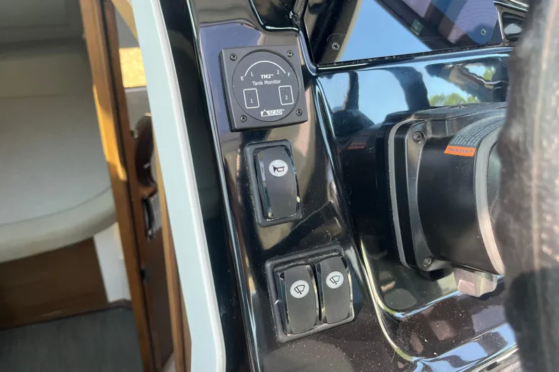 Slide: The Image of Control panel of a 2020 Jeanneau NC 895 boat with tank monitor and switches. - 22
