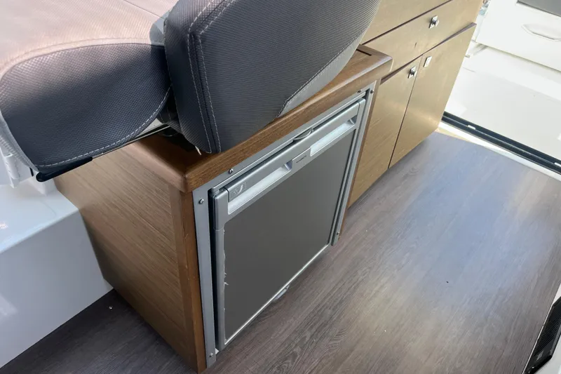 Slide: The Image of Interior of 2020 Jeanneau NC 895 boat with compact fridge and seating. - 29