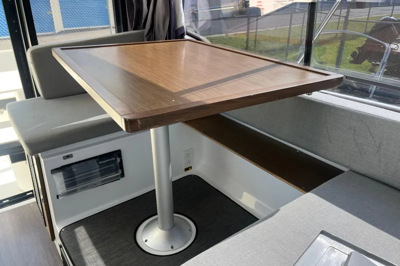 Slide: The Image of Interior of 2020 Jeanneau NC 895 boat with wooden table and seating area. - 31