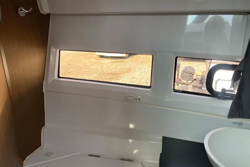 Slide: The Image of Interior view of 2020 Jeanneau NC 895 boat cabin with windows and sink. - 36