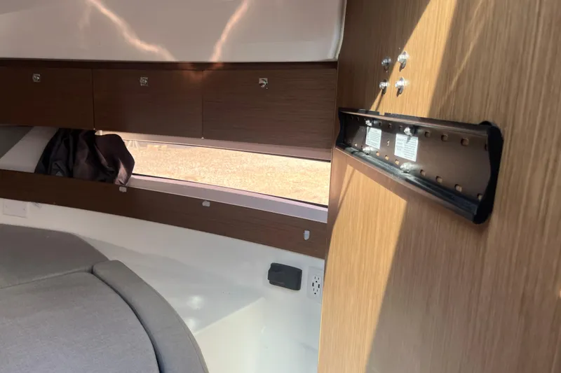 Slide: The Image of Interior of 2020 Jeanneau NC 895 boat with wood paneling and storage compartments. - 40