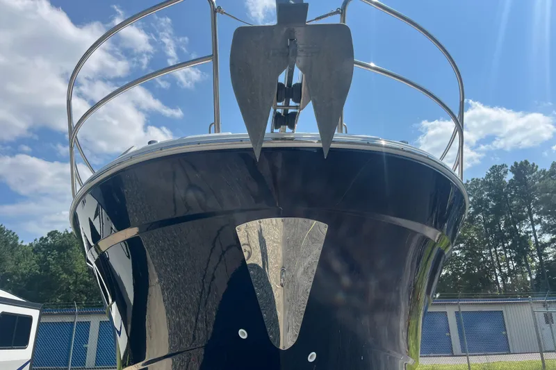 Slide: The Image of 2020 Jeanneau NC 895 boat with anchor, viewed from the front under a clear sky. - 5