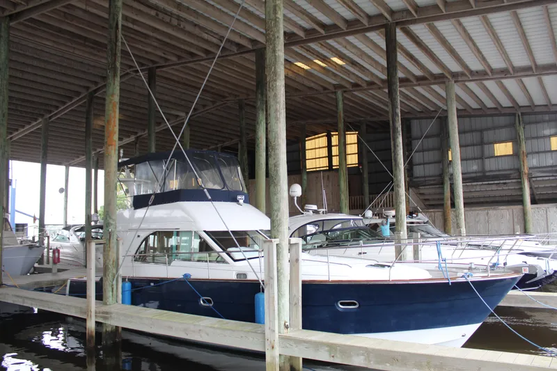 Slide: The Image of 2005 Beneteau Antares 13.80 yacht docked in a covered marina. - 0