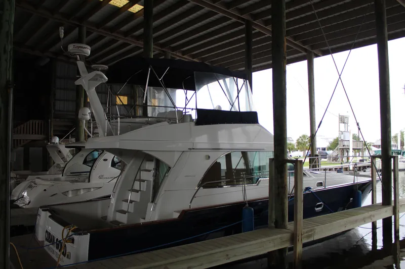 Slide: The Image of 2005 Beneteau Antares 13.80 yacht docked in a covered marina. - 1