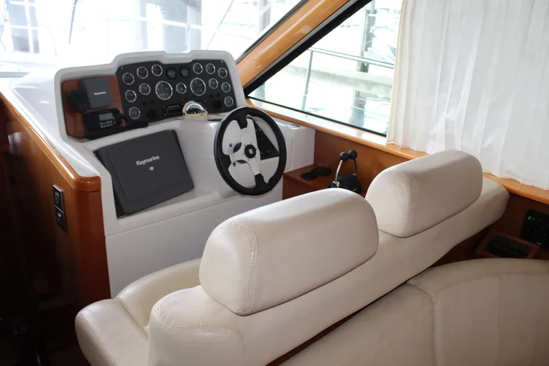 Slide: The Image of Helm station of 2005 Beneteau Antares 13.80 with leather seats and navigation equipment. - 12