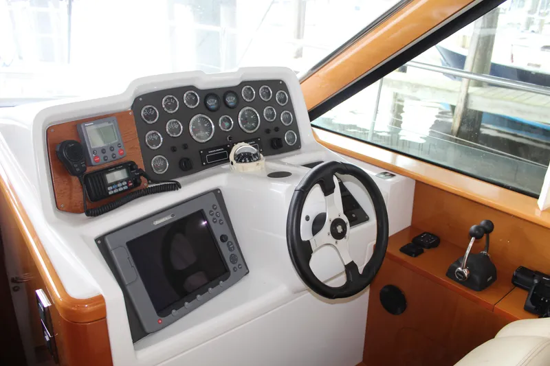 Slide: The Image of Helm station of a 2005 Beneteau Antares 13.80 with navigation instruments and steering wheel. - 13