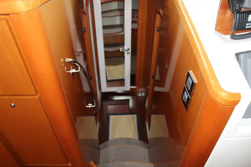 Slide: The Image of 2005 Beneteau Antares 13.80 interior stairs leading to lower cabin area. - 19