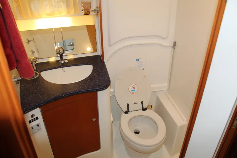 Slide: The Image of Compact bathroom in a 2005 Beneteau Antares 13.80 yacht with sink and toilet. - 21