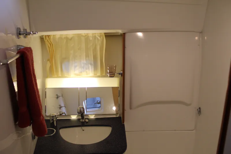 Slide: The Image of Beneteau Antares 13.80 2005 bathroom with sink, mirror, and towel. - 23