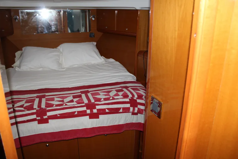 Slide: The Image of Cozy bedroom in 2005 Beneteau Antares 13.80 yacht with red and white quilt. - 24