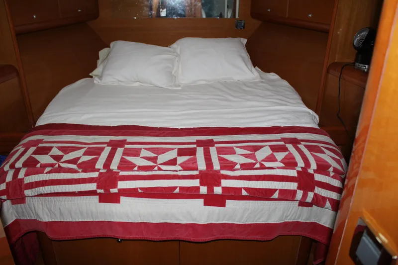 Slide: The Image of Cozy bedroom in a 2005 Beneteau Antares 13.80 with a red and white quilt. - 25