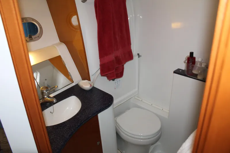 Slide: The Image of Compact bathroom in 2005 Beneteau Antares 13.80 yacht with sink, toilet, and mirror. - 26