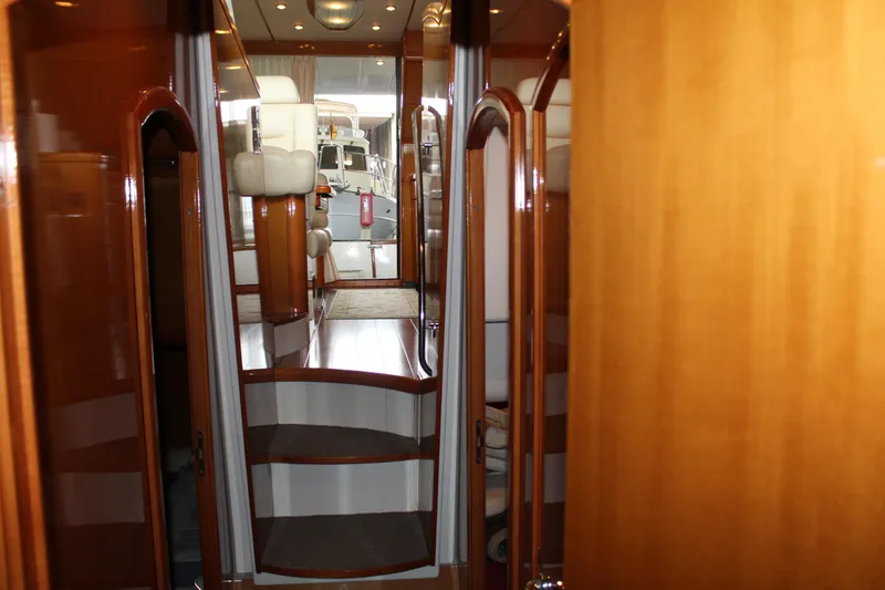 Slide: The Image of Interior of 2005 Beneteau Antares 13.80 yacht with polished wood finish and stairs. - 29