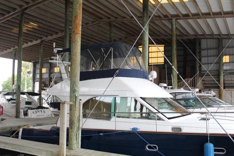 Slide: The Image of 2005 Beneteau Antares 13.80 yacht docked in a covered marina. - 3