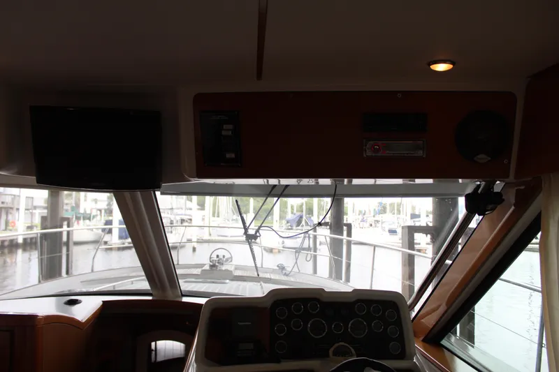 Slide: The Image of Interior helm of 2005 Beneteau Antares 13.80 yacht with marina view. - 34