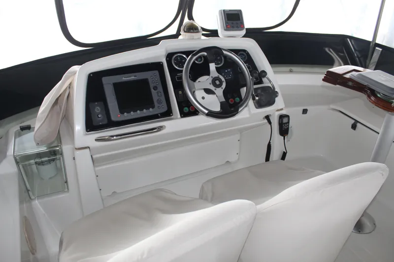 Slide: The Image of Helm station of 2005 Beneteau Antares 13.80 with navigation equipment and dual seats. - 35