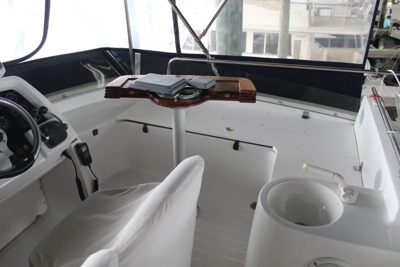 Slide: The Image of Cockpit of 2005 Beneteau Antares 13.80 with steering wheel and seating area. - 37