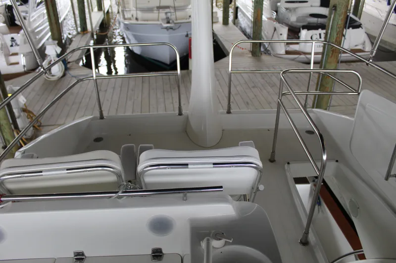Slide: The Image of Beneteau Antares 13.80 2005 model, spacious deck with seating, docked in marina. - 38