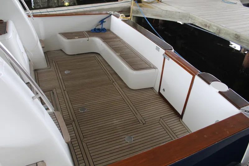 Slide: The Image of 2005 Beneteau Antares 13.80 boat deck with wooden flooring and seating. - 4