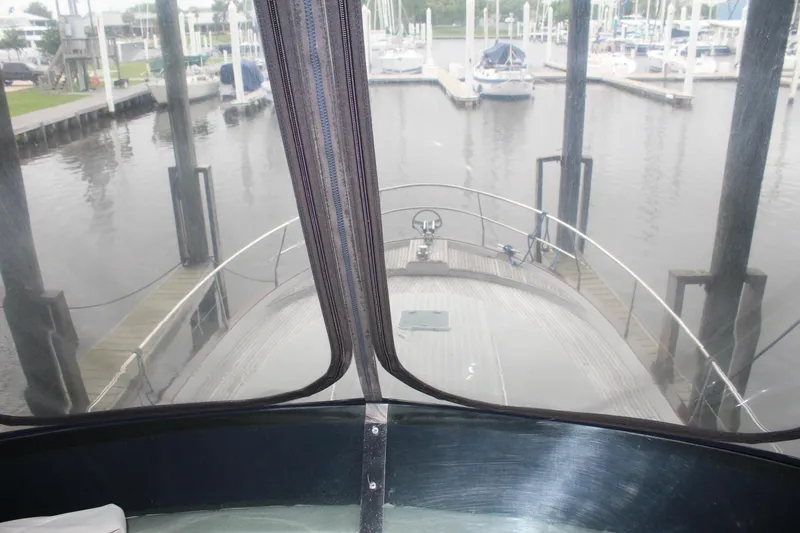 Slide: The Image of View from the helm of a 2005 Beneteau Antares 13.80 yacht docked at a marina. - 41