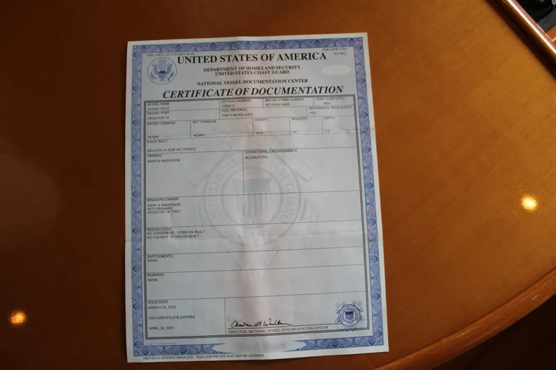 Slide: The Image of Certificate of Documentation for 2005 Beneteau Antares 13.80 on wooden surface. - 44