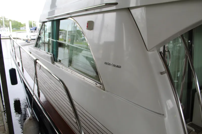 Slide: The Image of 2005 Beneteau Antares 13.80 yacht side view with sleek design and railing. - 6