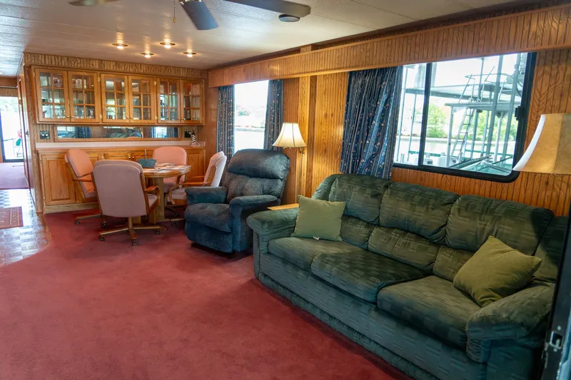 Slide: The Image of Interior of a 1995 Lakeview 62 x 14 Widebody Houseboat with cozy seating and dining area. - 14