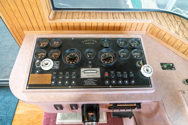 Slide: The Image of Control panel of a 1995 Lakeview 62 x 14 Widebody Houseboat with gauges and switches. - 18