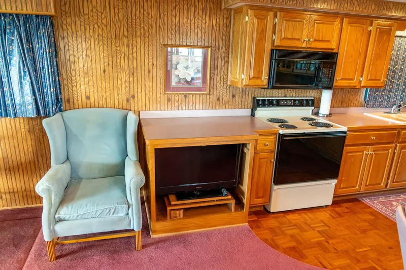 Slide: The Image of Interior of 1995 Lakeview houseboat with kitchen and seating area. - 22