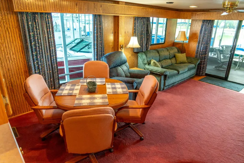 Slide: The Image of Interior of 1995 Lakeview 62 x 14 Widebody Houseboat with cozy seating and dining area. - 25