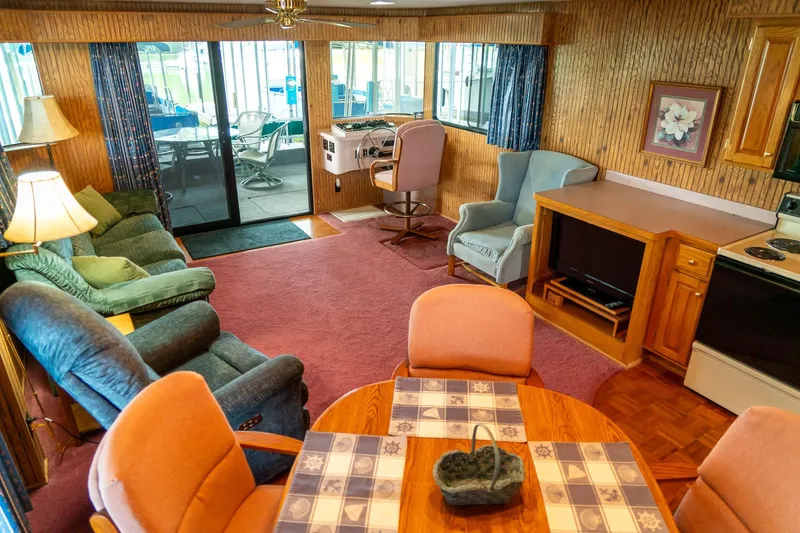 Slide: The Image of Interior of a 1995 Lakeview 62 x 14 Widebody Houseboat with cozy seating and dining area. - 26