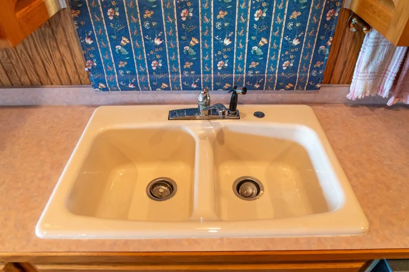 Slide: The Image of Double kitchen sink in 1995 Lakeview houseboat with floral wallpaper background. - 28